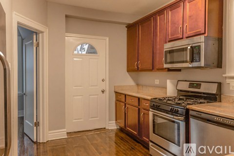 A kitchen with wooden cabinets and stainless steel appliances.