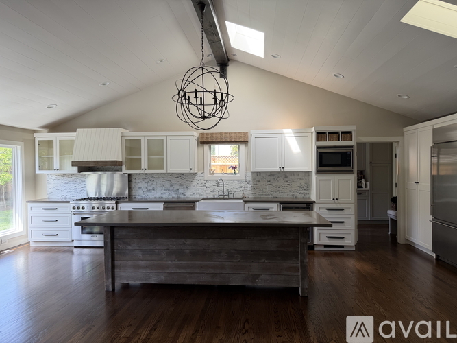 A modern kitchen with a large island in the center.