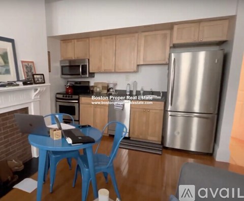 A kitchen with a blue table and chairs.