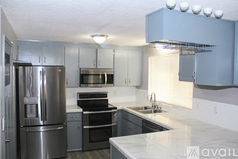 A kitchen with a stainless steel refrigerator and oven.