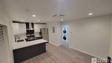 A kitchen with a stove top oven and a dishwasher.