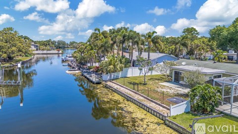 A serene waterfront scene with a dock and buildings.
