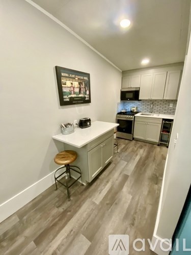 A kitchen with a white counter and a fridge.