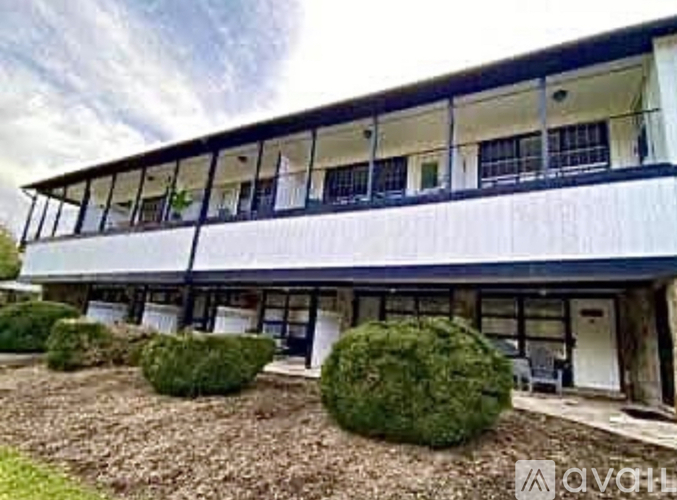 A white building with black railings and windows.