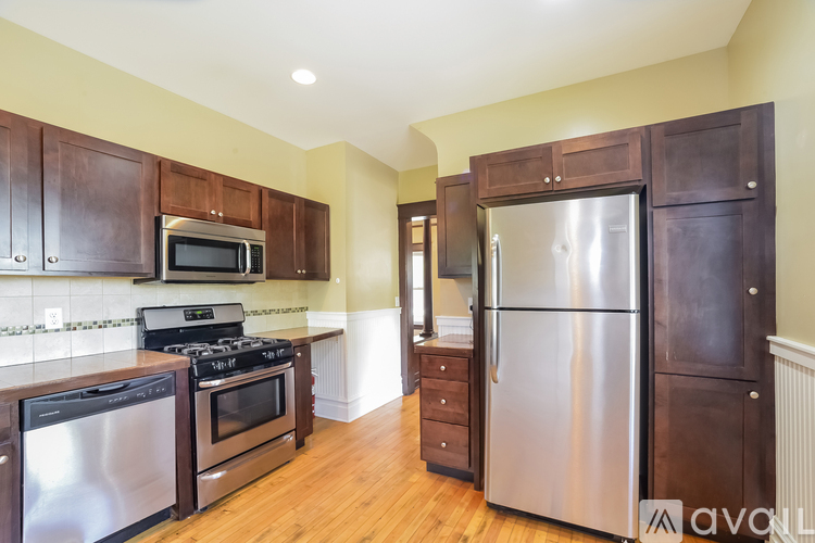 A kitchen with wooden cabinets and stainless steel appliances.