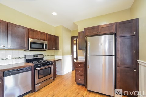 A kitchen with wooden cabinets and stainless steel appliances.