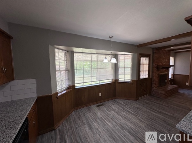 A living room with a fireplace and a large window.