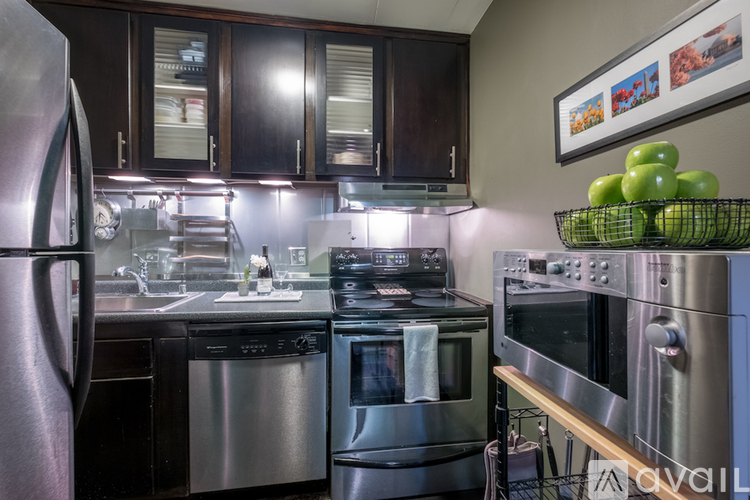 A kitchen with a stainless steel refrigerator and oven.