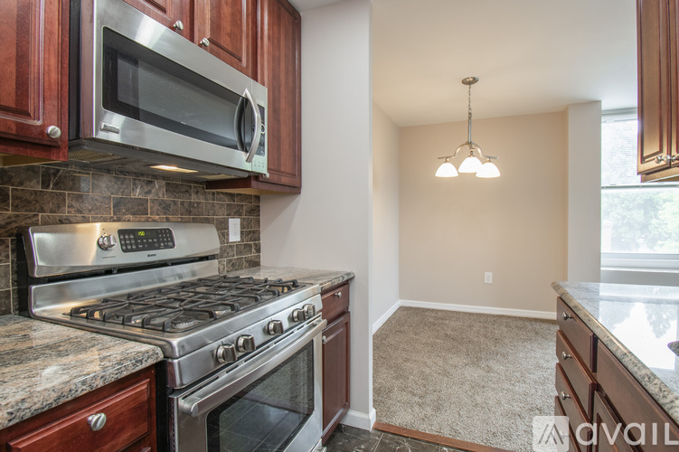 A kitchen with a stove top oven and microwave above it.