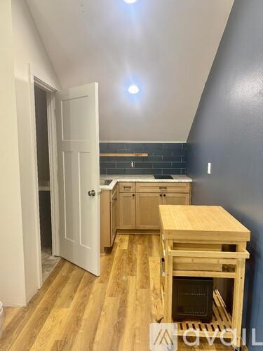 A kitchen with a wooden table and cabinets is under renovation.