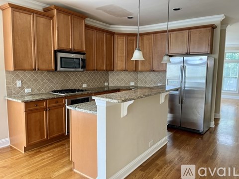 A kitchen with wooden cabinets and a granite countertop.