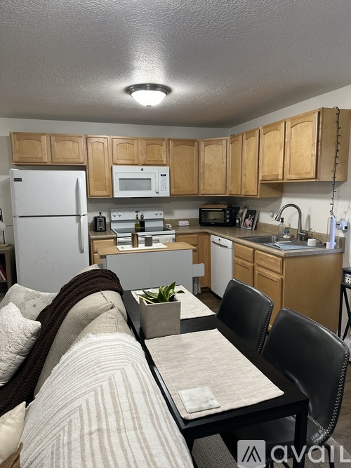 A kitchen with wooden cabinets and a white refrigerator.
