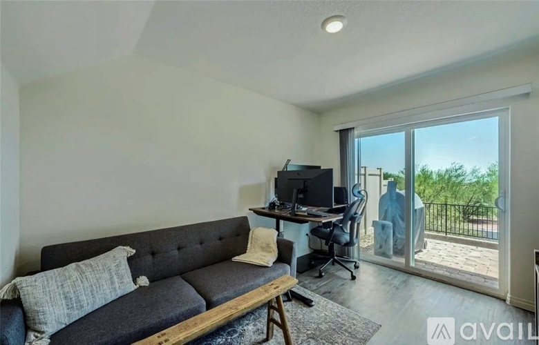 A living room with a grey couch and a television.