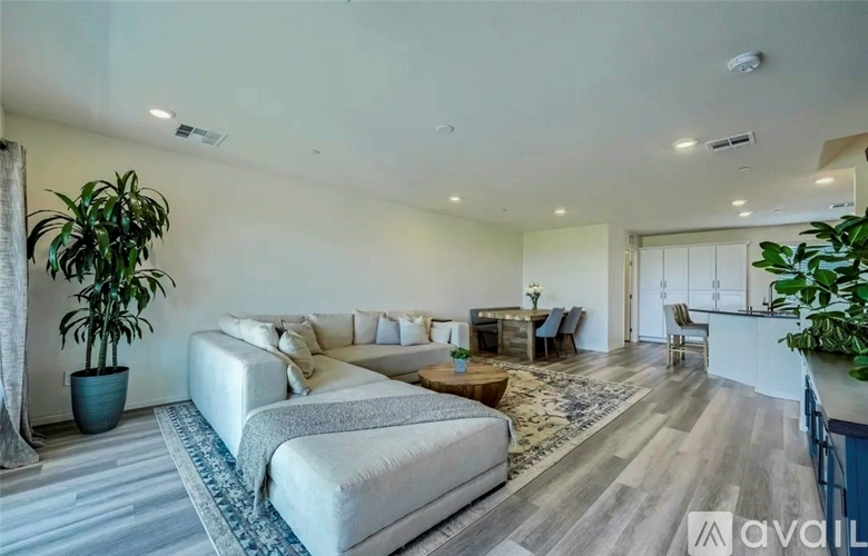 A spacious living room with a large couch and a coffee table.