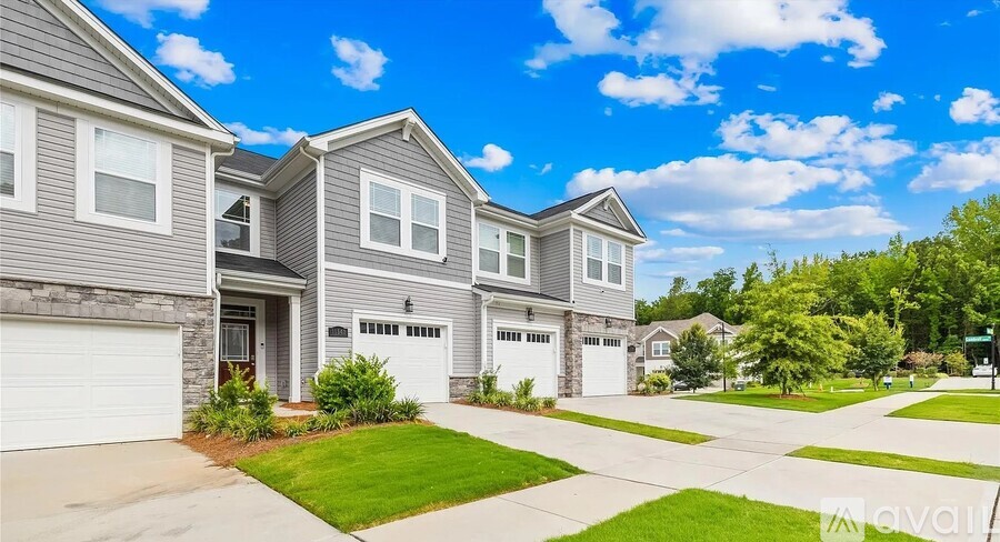 A house with a driveway and garage is for sale.