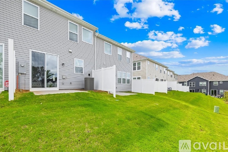 A row of houses with a grassy area in front.