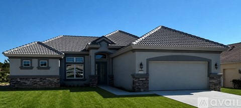 A house with a grey roof and a white garage door.