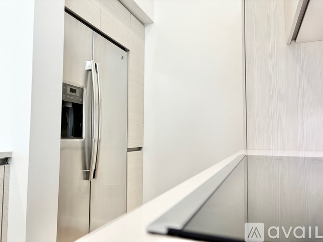 A stainless steel refrigerator with a water dispenser on the door.