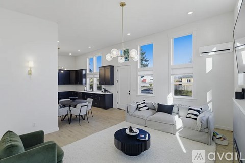A living room with a grey sofa and a black coffee table.