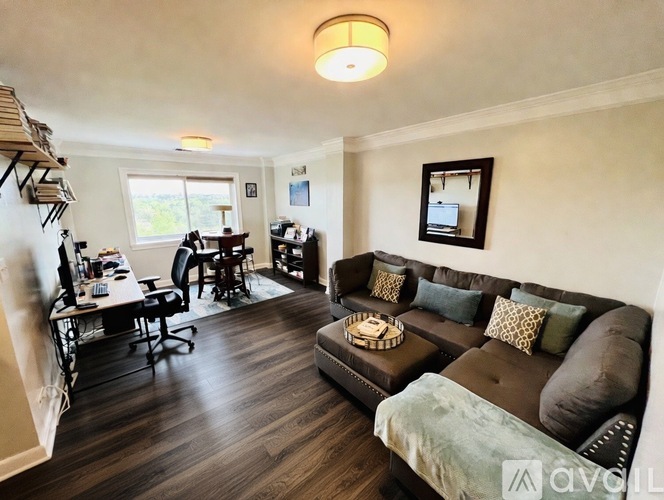 A living room with a brown couch and a coffee table.