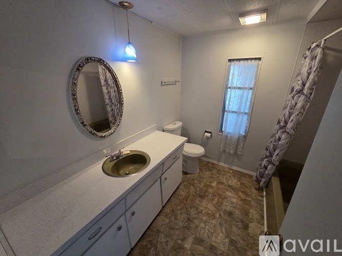 A bathroom with a sink, toilet, and shower.