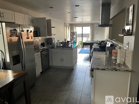 A kitchen with white cabinets and stainless steel appliances.