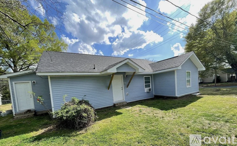 A house with a blue siding and a white door is shown.