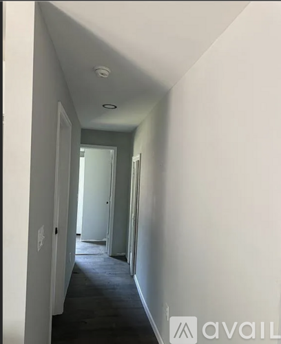 A long hallway with a door at the end.