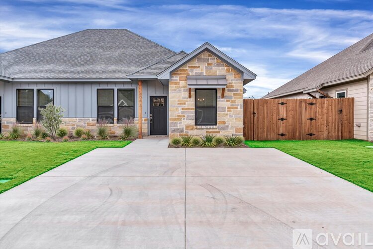 A house with a driveway in front of it.