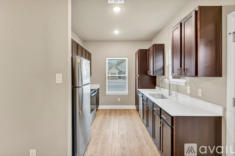 A kitchen with wooden cabinets and a white countertop.