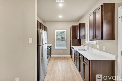 A kitchen with wooden cabinets and a white countertop.