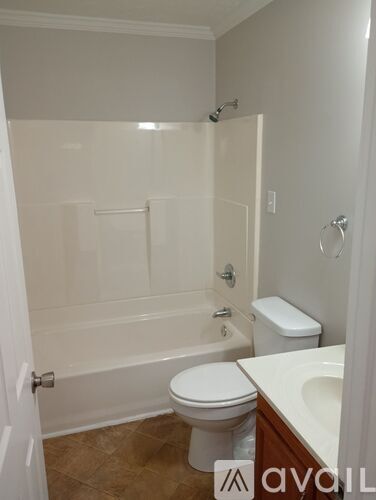 A bathroom with a toilet, sink, and bathtub.