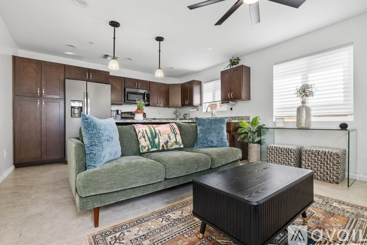 A living room with a green couch and a black coffee table.