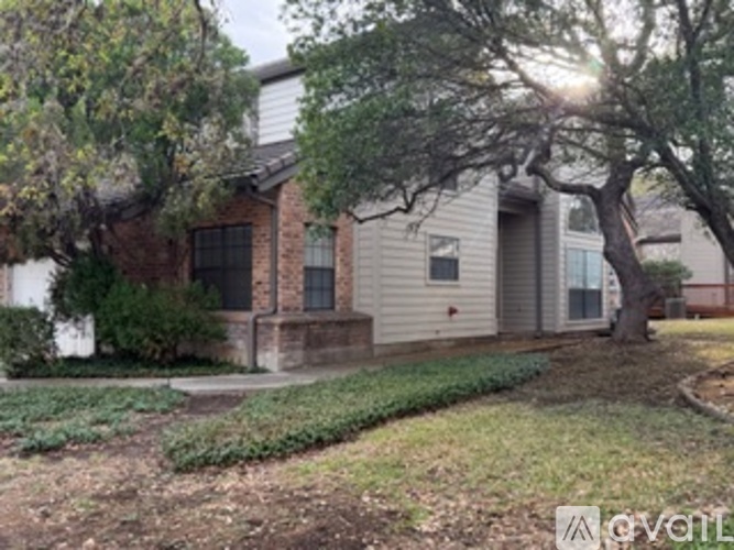 A house with a tree in front of it.