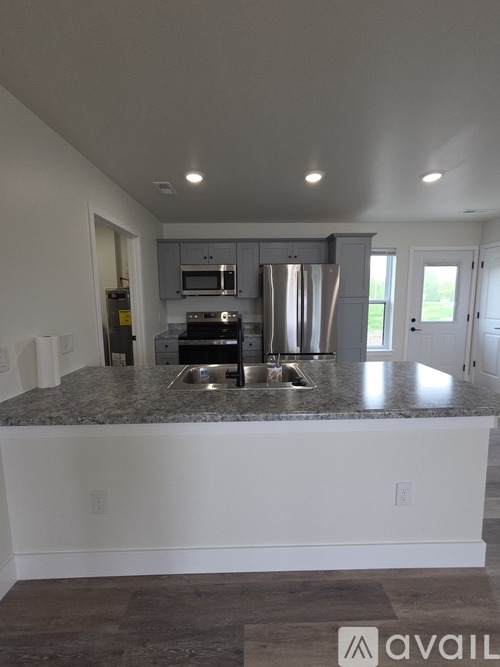 A kitchen with granite countertops and stainless steel appliances.