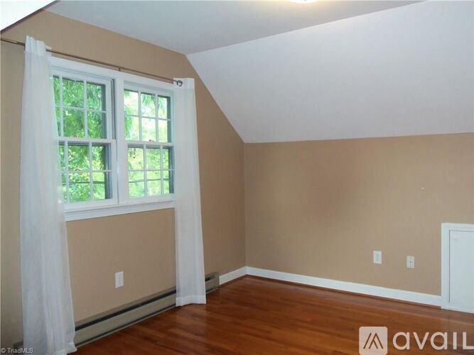 A room with a window and a door.