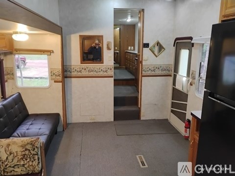 A living room with a couch and a television.