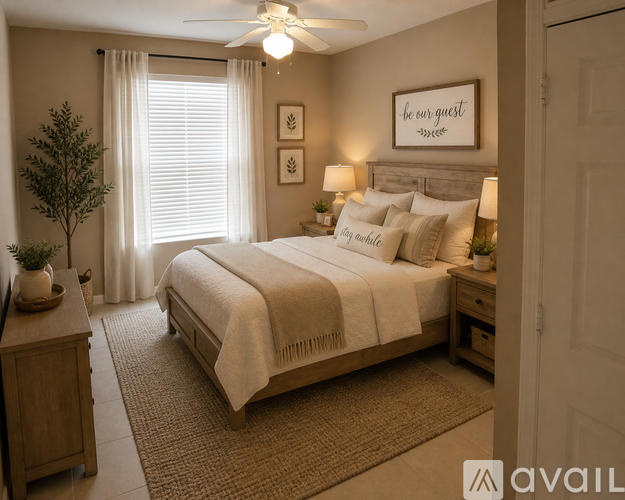 A well-lit bedroom with a large bed and a ceiling fan.
