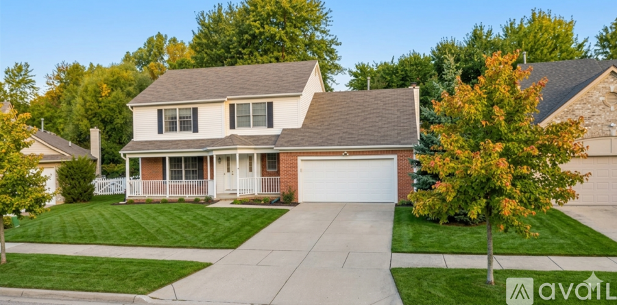 A house with a brown roof and a white garage door.