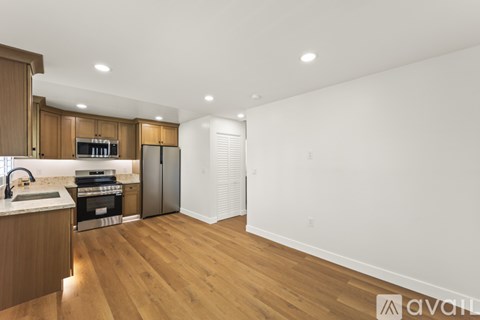 A kitchen with wooden cabinets and a white countertop.