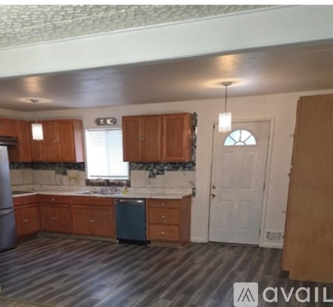 A kitchen with wooden cabinets and a white countertop.
