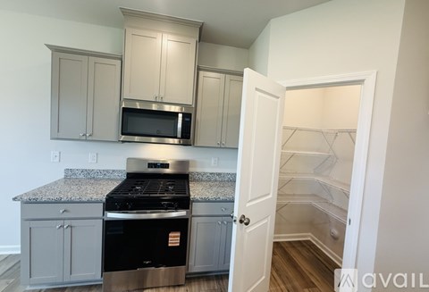 A kitchen with a stove top oven and microwave above it.