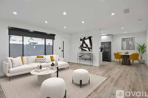 A modern living room with a white sofa and a yellow chair.
