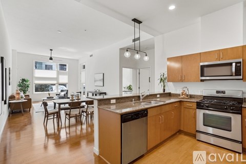 A modern kitchen with wooden cabinets and a large island.