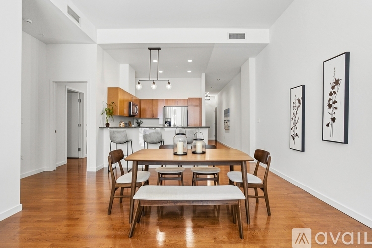 A dining room with a wooden table and chairs.