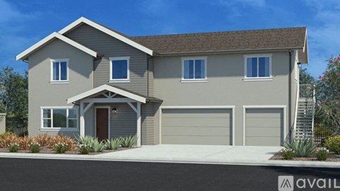 A modern house with a brown roof and a garage door.