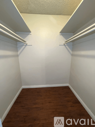 A room with white walls and wooden flooring.