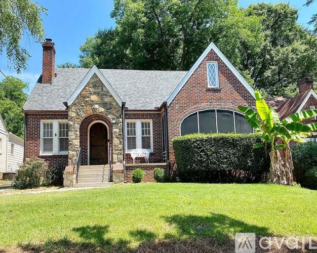 A brick house with a white window and a door.