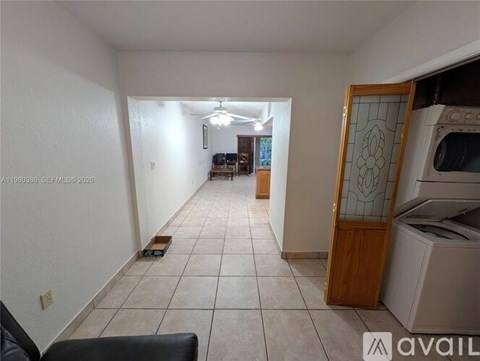 A kitchen area with a microwave, oven, and a dining table with chairs.