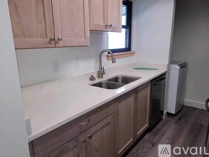 A kitchen with wooden cabinets and a marble countertop.